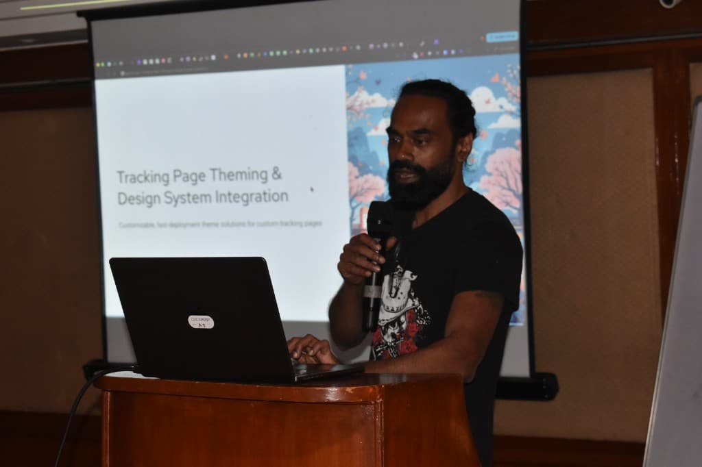 Presenter at a podium speaking about tracking page theming and design system integration